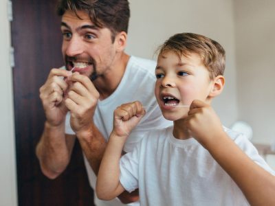 Father and son flossing together