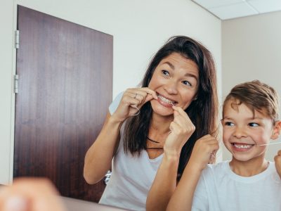 mother showing child that dental hygiene can be fun