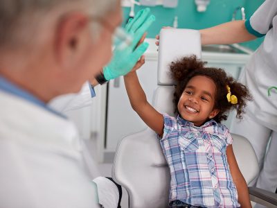 smiling kid is having positive dental experience - high five